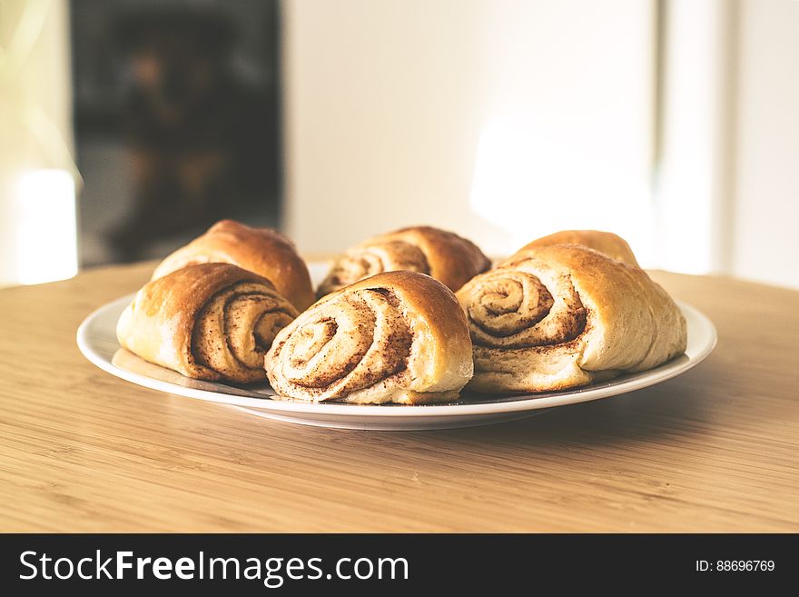 A close up of homemade cinnamon buns on a plate.