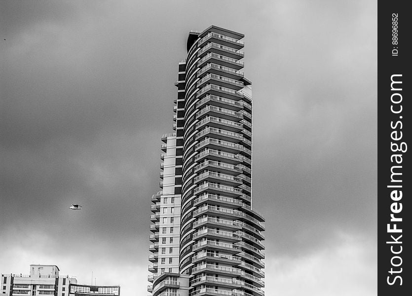 A black and white photo of a modern tall office building.