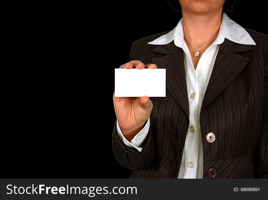 Woman in Brown Stripe Blazer Holding White Card