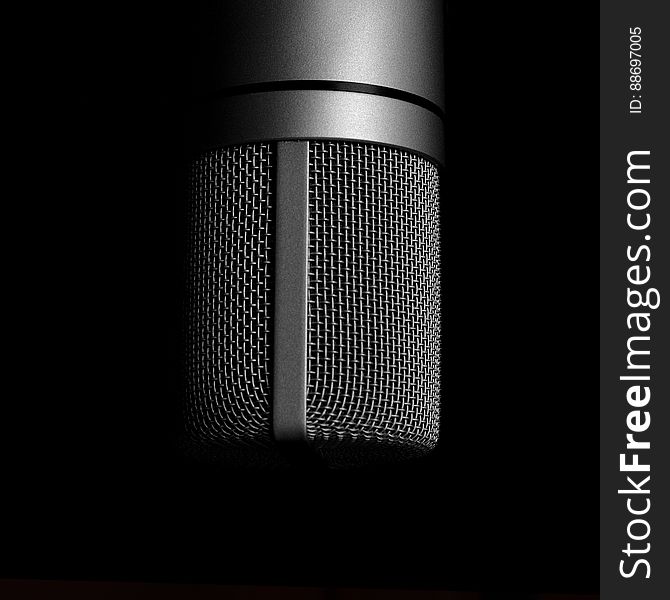 A close up of a microphone in black and white. A close up of a microphone in black and white.