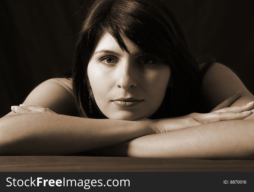 Portrait of young woman on black background