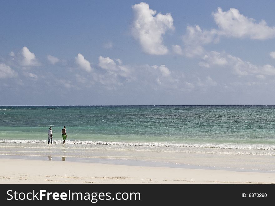 Two men look out on the Caribbean sea from a beach in Freeport Grand Bahama Island. Two men look out on the Caribbean sea from a beach in Freeport Grand Bahama Island