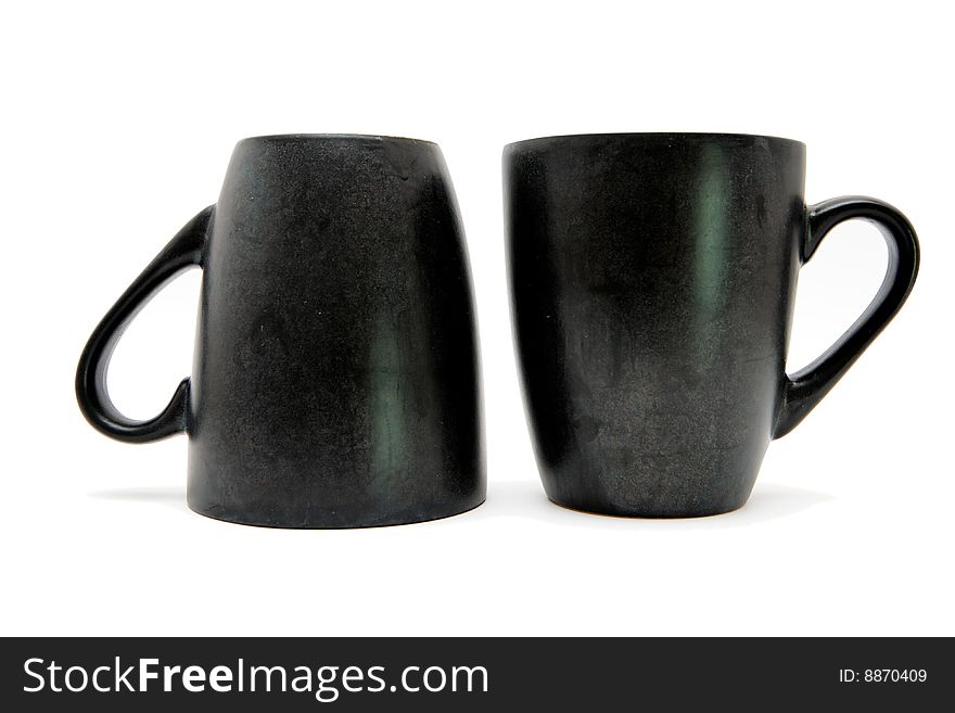Two black coffee cups up and down isolated. Two black coffee cups up and down isolated