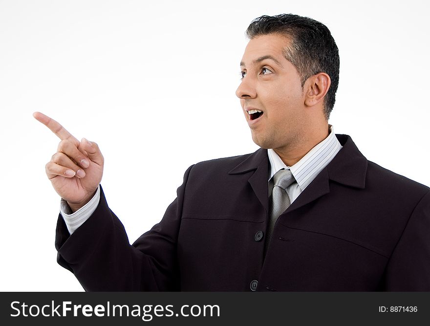 Portrait of businessman pointing aside with white background