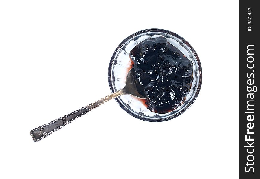 Black-currant jam in glass rosette with tea spoon. Black-currant jam in glass rosette with tea spoon