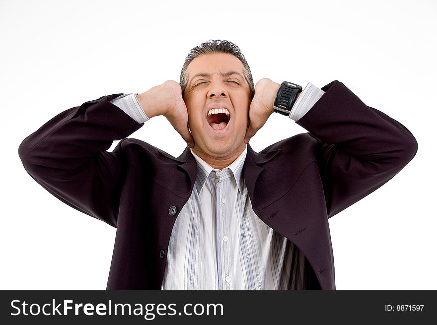 Front view of shouting businessman putting hands on his ears with white background