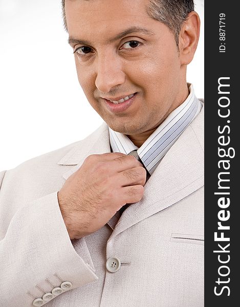 Close view of smiling businessman holding tie