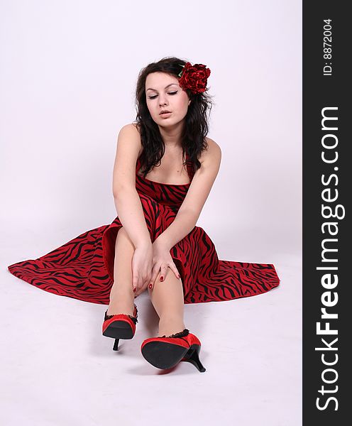 Pretty pinup girl sitting in studio