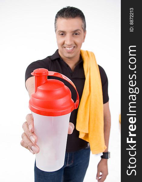 Front view of smiling man offering water bottle with white background