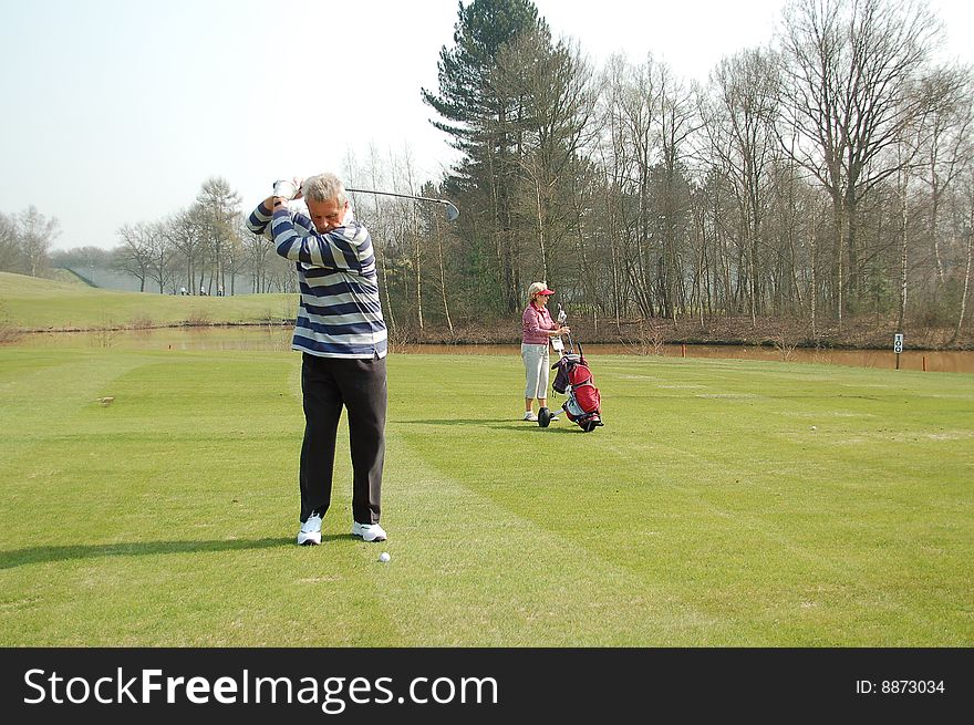 Male Golfer Teeing Off