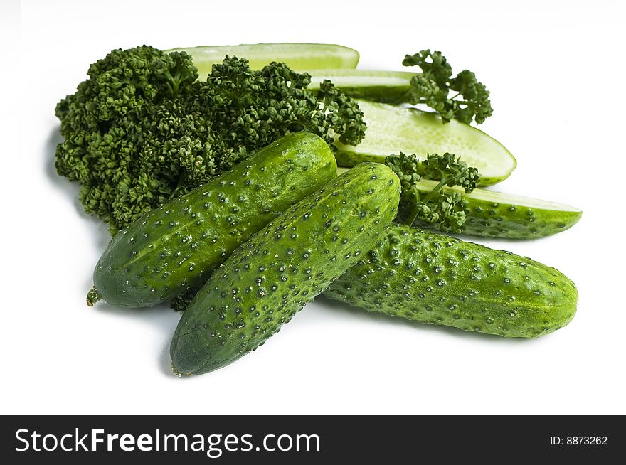 Cutted and whole cucumbers and parsley