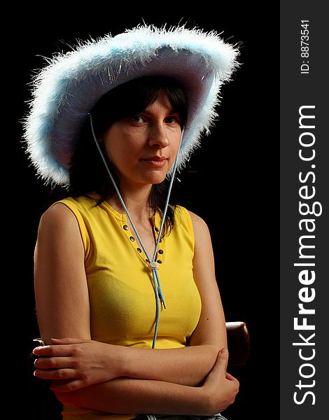 Brunette girl with cowboy hat, isolated on black