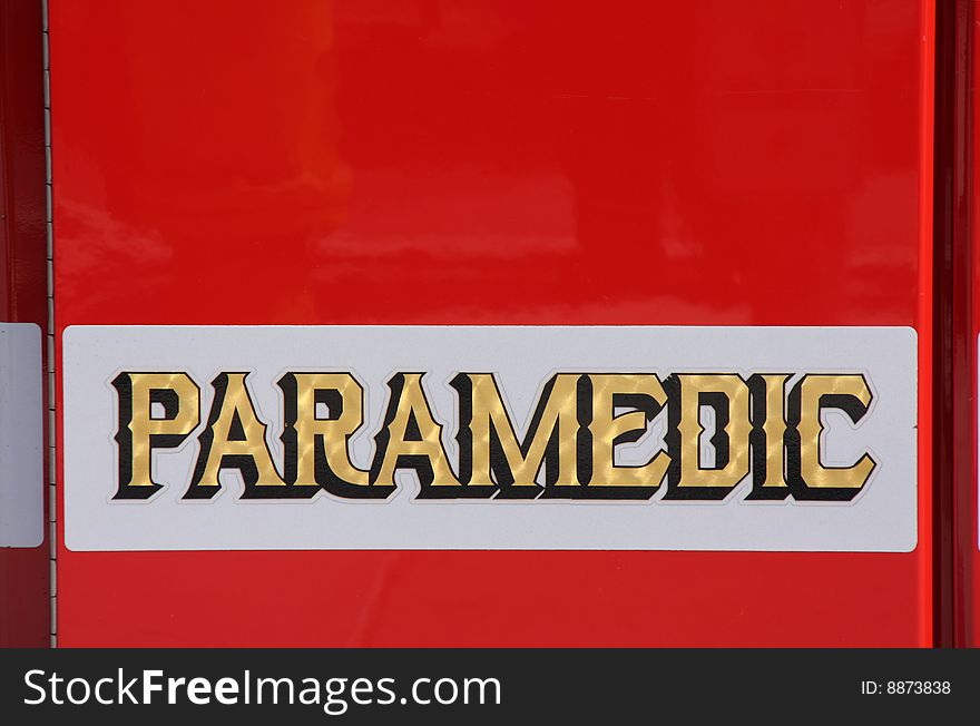 View of paramedic writing on red fire fighter truck