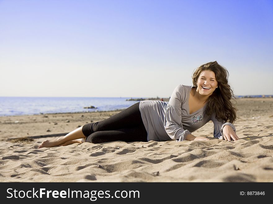 Beautiful brunette girl on the beach