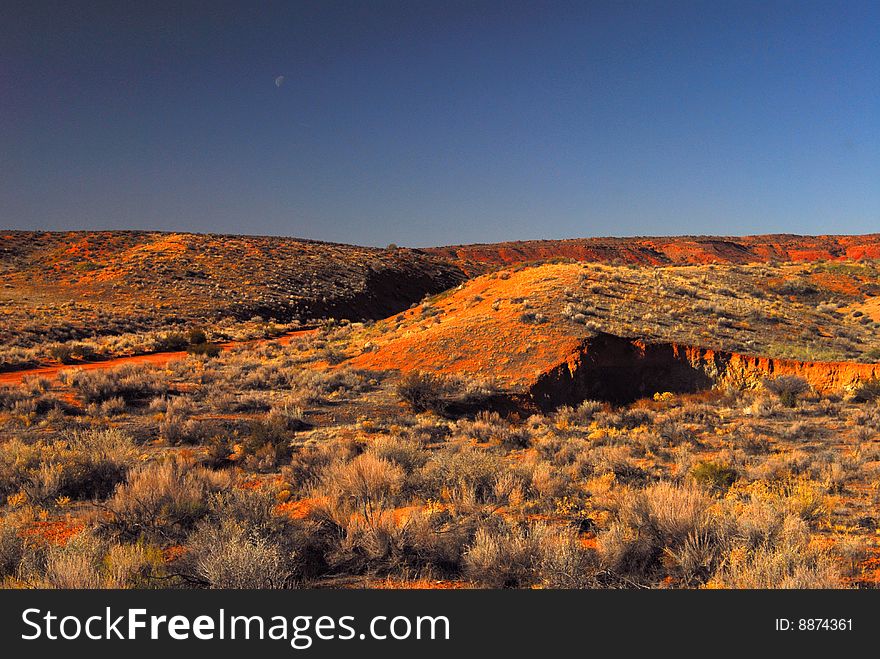 High desert landscape and moon in Arches