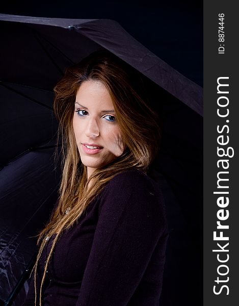 Portrait of smiling young woman holding umbrella