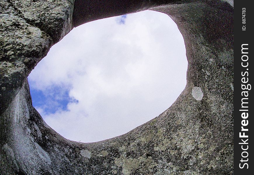 Sky view through granite rock weathered by time. Sky view through granite rock weathered by time