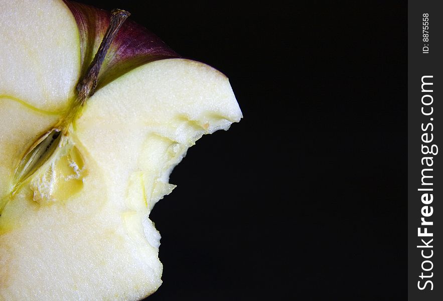 Macro detail of the apple and cut in isolated black background, food and nutrition