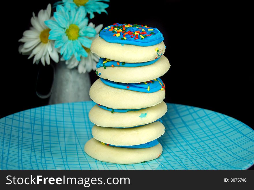 Stack of sugar cookies with daisy bouquet. Stack of sugar cookies with daisy bouquet.