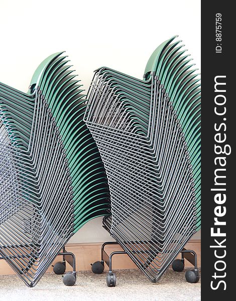 Graphic view of stacked chairs in a conference room.