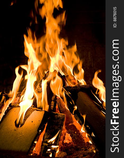 A closeup view of wood burning in a fireplace.