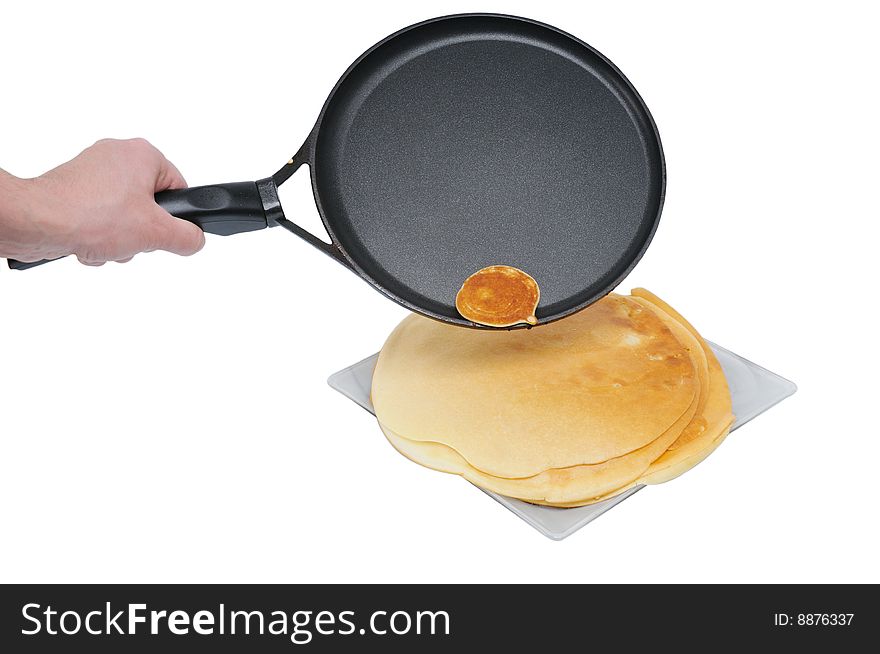 Small slapjack lie on frying pan; isolated on white