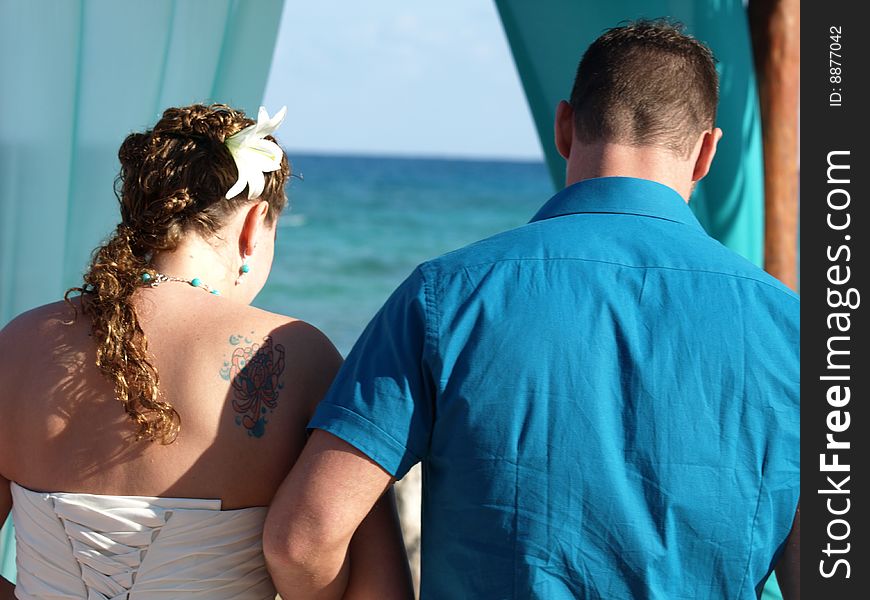 Young couple getting married on the beach in mexico this is a good way to have your wedding and honeymoon. Young couple getting married on the beach in mexico this is a good way to have your wedding and honeymoon.