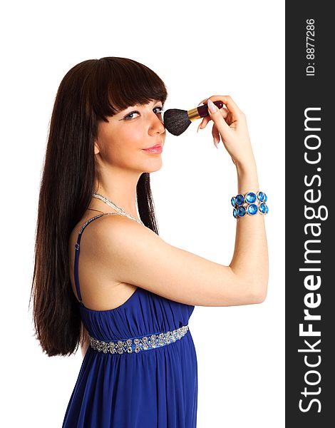 Young beautiful long hair brunette in blue dress takes make up