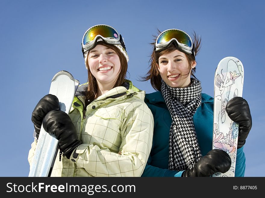 Portrait Of Two Girls Holding There Skis