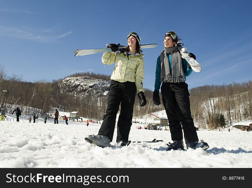 Two Girl Skiers Looking Up Towards Mountain