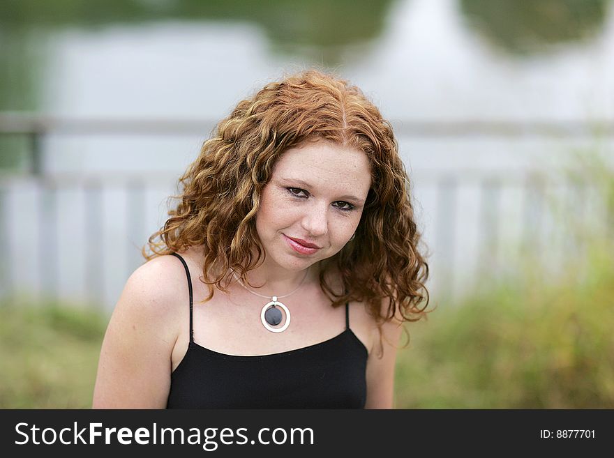 Headshot portrait of one thin redhead woman outdoors. Headshot portrait of one thin redhead woman outdoors