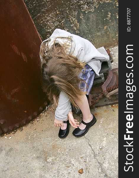 One sad looking young female holding her head and covering face. One sad looking young female holding her head and covering face