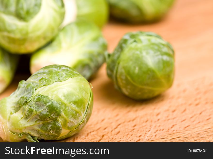 Close up of brussel sprouts on a wood cutting block. Close up of brussel sprouts on a wood cutting block