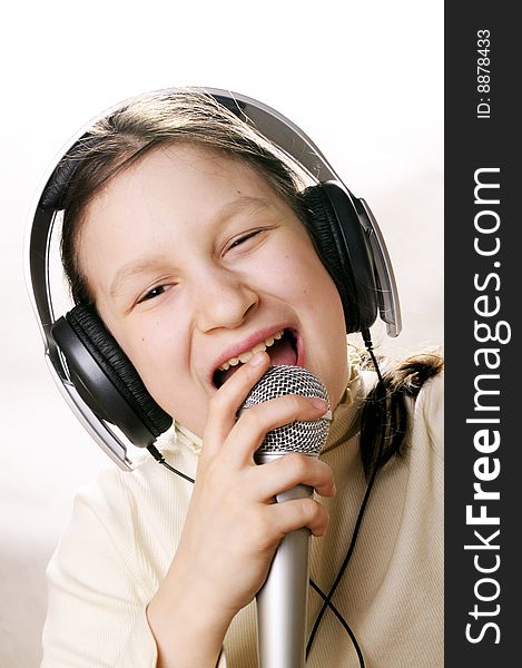 Young girl with microphone singing a song. Young girl with microphone singing a song