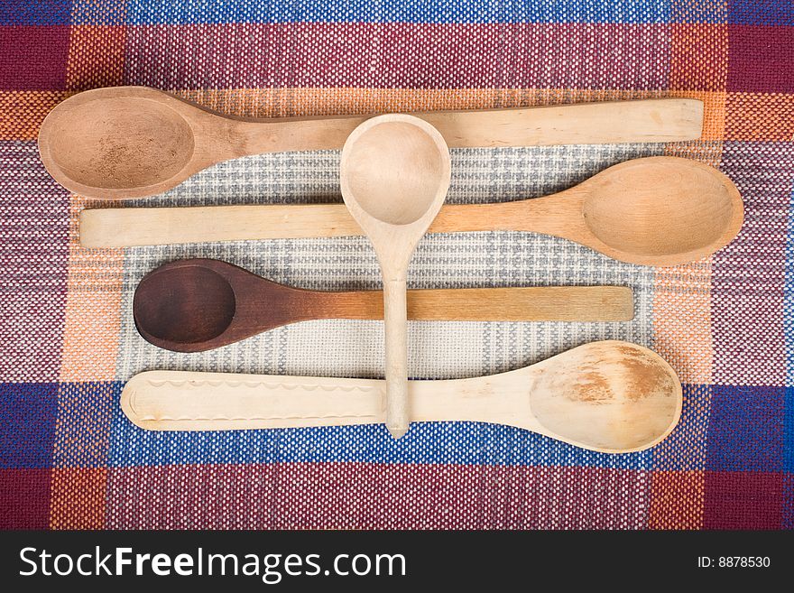 Wooden spoons on a colour sacking. Wooden spoons on a colour sacking