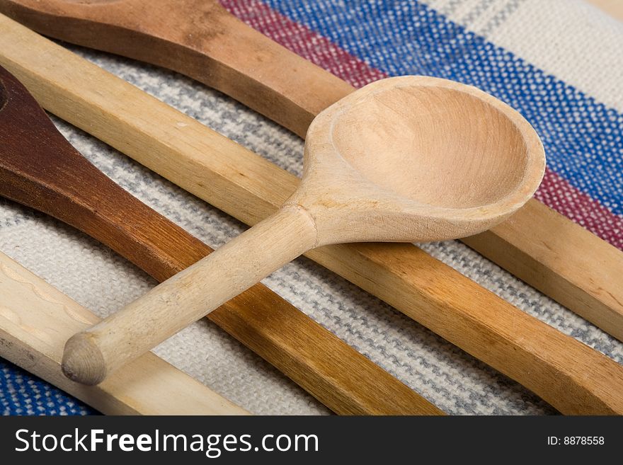 Macro wooden spoon on a colour sacking. Macro wooden spoon on a colour sacking