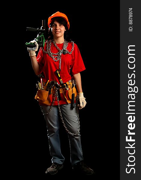 Young woman with work tools and drill, isolated on black