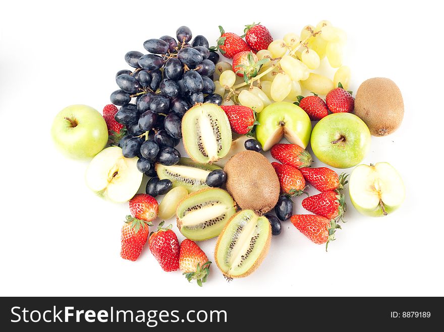 Assorted fresh fruits background including strawberry, apple, kiwi and black and green grape