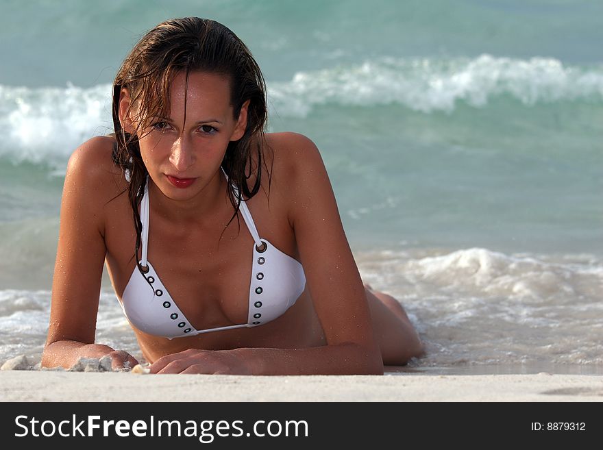 Woman in white bikinis lying on the beach. Woman in white bikinis lying on the beach