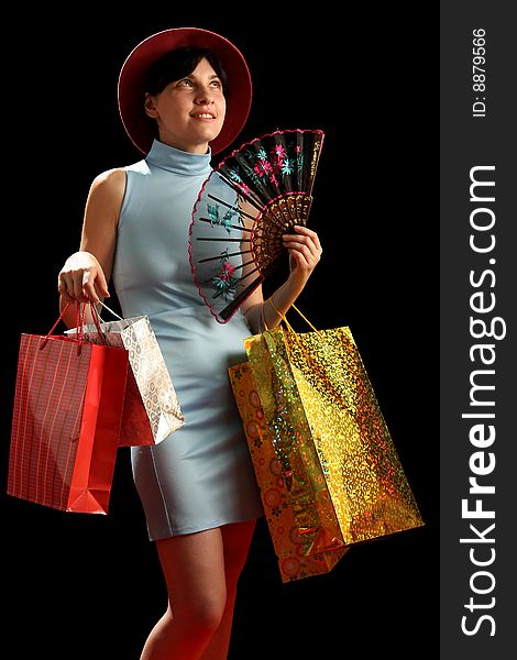 Young woman with shopping bags, isolated on black