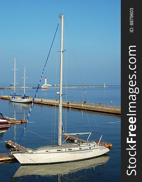 White yacht docked in a sea port