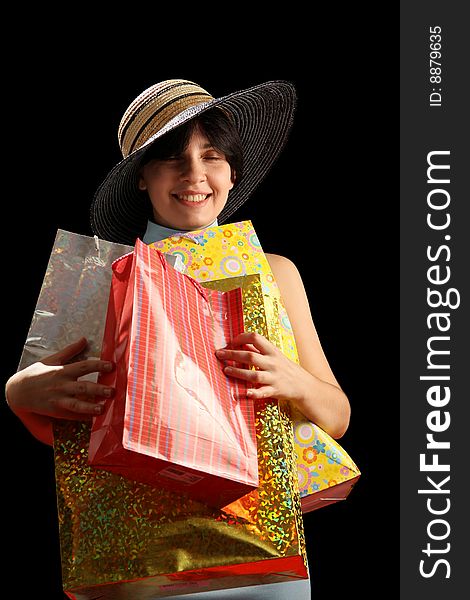 Young woman with shopping bags, isolated on black