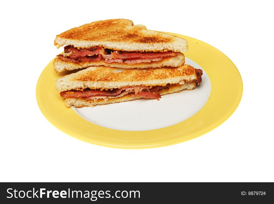 Toasted bacon sandwich on a plate isolated on white