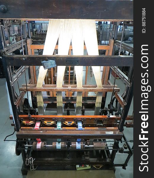 A ribbon loom. Programmable using punch cards and used for complex designs such as labels. A ribbon loom. Programmable using punch cards and used for complex designs such as labels.