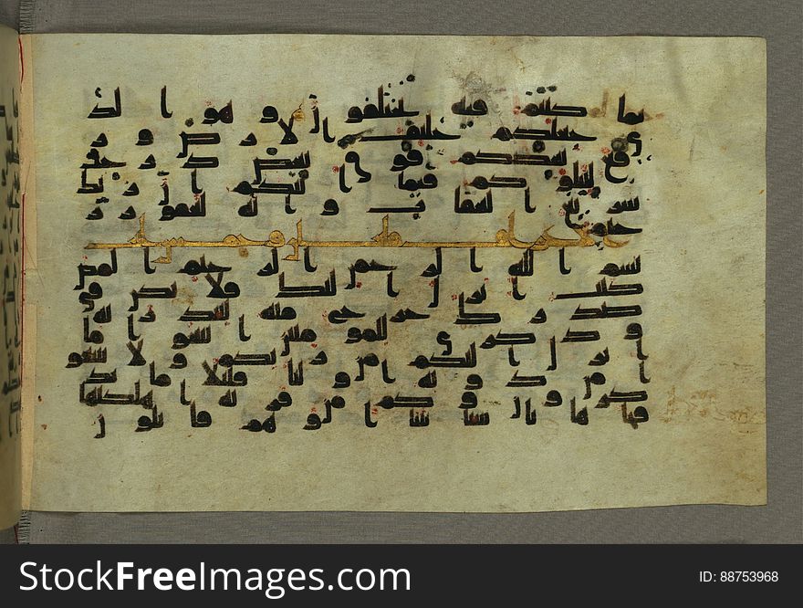 This horizontal-format manuscript on parchment is an illuminated fragment of the Qur&#x27;an, covering chapter 6 &#x28;Sūrat al-anʿām&#x29;, the end of verse 54, through chapter 9 &#x28;Sūrat al-tawbah&#x29;, verse 79. The fragment probably dates to the third century AH / ninth CE. The text is written in an Early Abbasid &#x28;Kufic&#x29; script in dark brown ink and vocalized with red dots. Chapter headings are in gold ink, and verse markers in the shape of a stylized letter hā&#x27; and rosettes with colored dots indicate groups of five and ten verses. The green goatskin binding with gold-painted central floral design and cornerpieces is thirteenth century AH / nineteenth CE or later. See this manuscript page by page at the Walters Museum Website: art.thewalters.org/viewwoa.aspx?id=1528. This horizontal-format manuscript on parchment is an illuminated fragment of the Qur&#x27;an, covering chapter 6 &#x28;Sūrat al-anʿām&#x29;, the end of verse 54, through chapter 9 &#x28;Sūrat al-tawbah&#x29;, verse 79. The fragment probably dates to the third century AH / ninth CE. The text is written in an Early Abbasid &#x28;Kufic&#x29; script in dark brown ink and vocalized with red dots. Chapter headings are in gold ink, and verse markers in the shape of a stylized letter hā&#x27; and rosettes with colored dots indicate groups of five and ten verses. The green goatskin binding with gold-painted central floral design and cornerpieces is thirteenth century AH / nineteenth CE or later. See this manuscript page by page at the Walters Museum Website: art.thewalters.org/viewwoa.aspx?id=1528