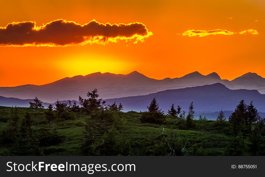 Scenic View Of Mountains Against Sky At Sunset