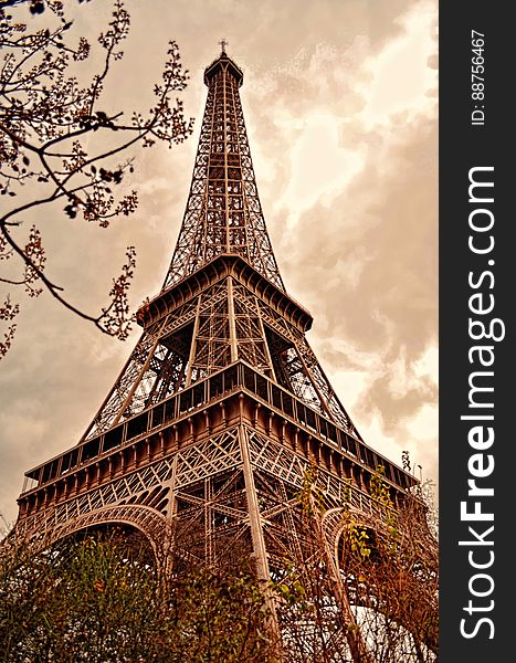 Low angle sepia view looking to top of Eiffel tower in Paris, France.