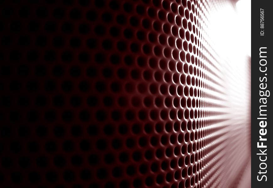An abstract background with grill with small round holes.