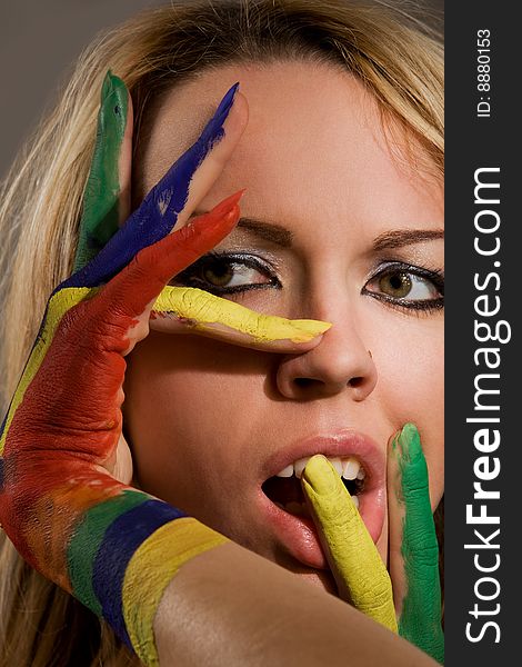 Pretty female model with hands painted rainbow style. Pretty female model with hands painted rainbow style