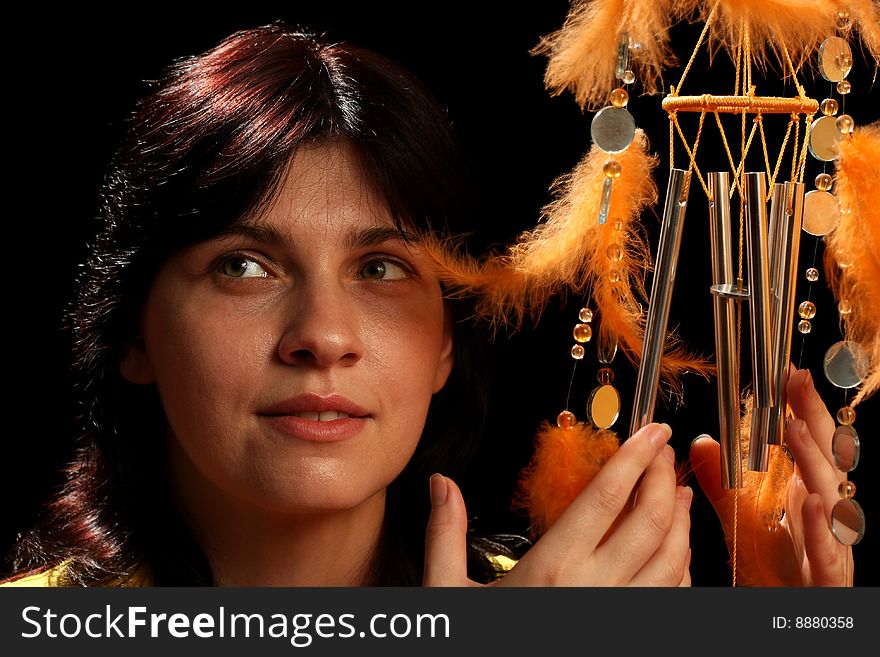 Young brunette and wind chime